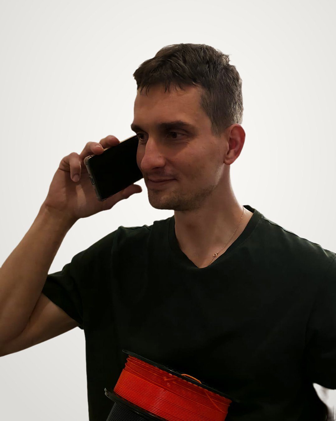 Michal telefonuje s cívkou filamentu v ruce